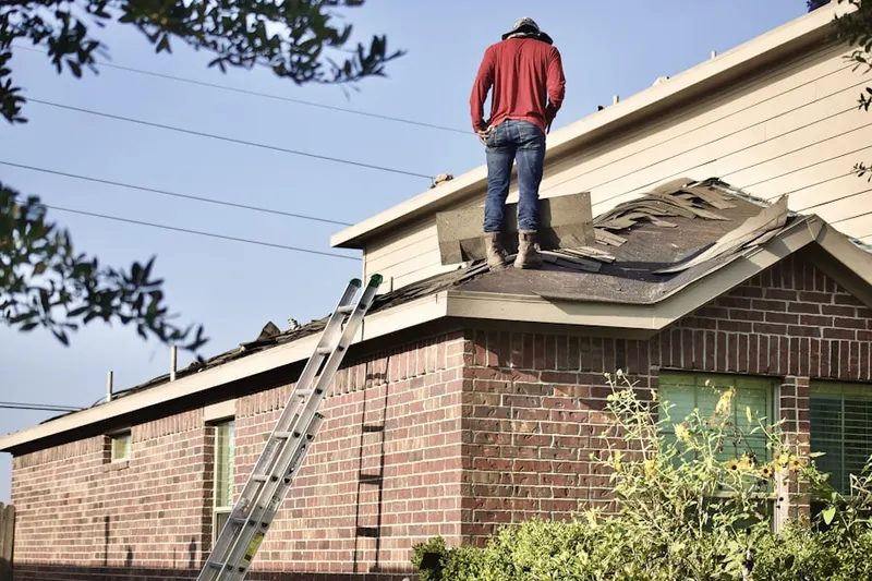 Professional roofer working on a residential roof in East Windsor